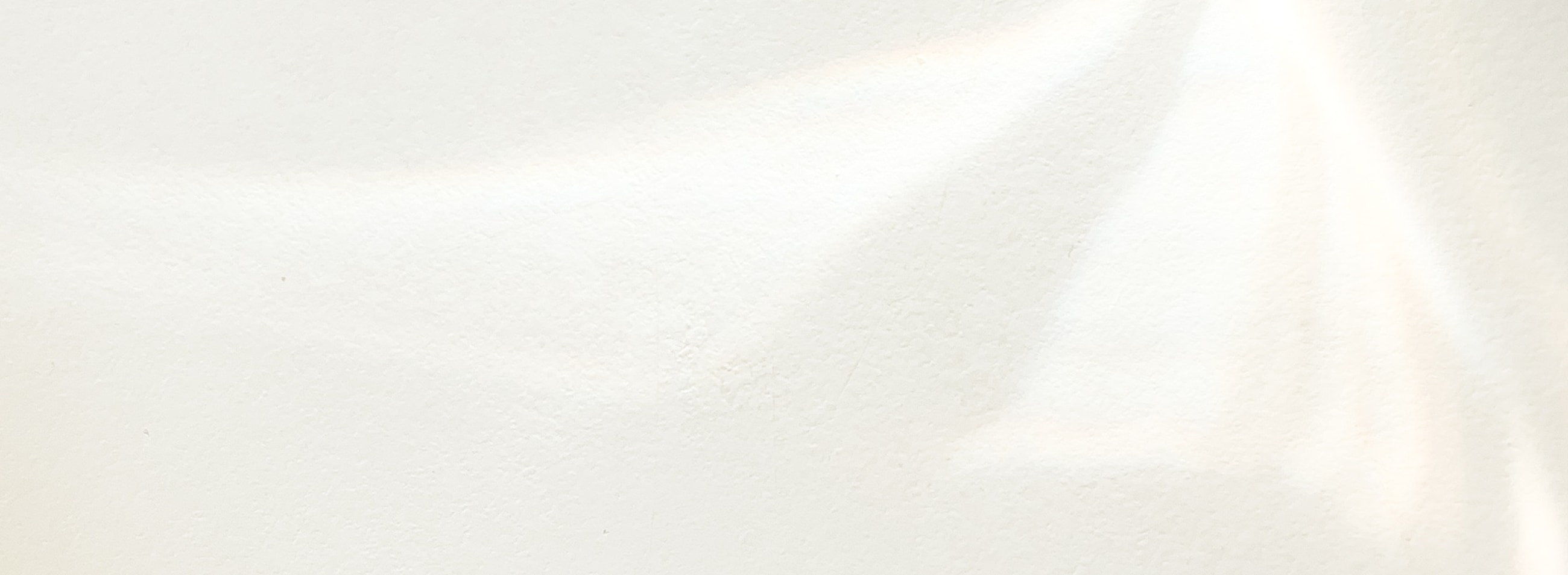 Soft white bokeh background texture.