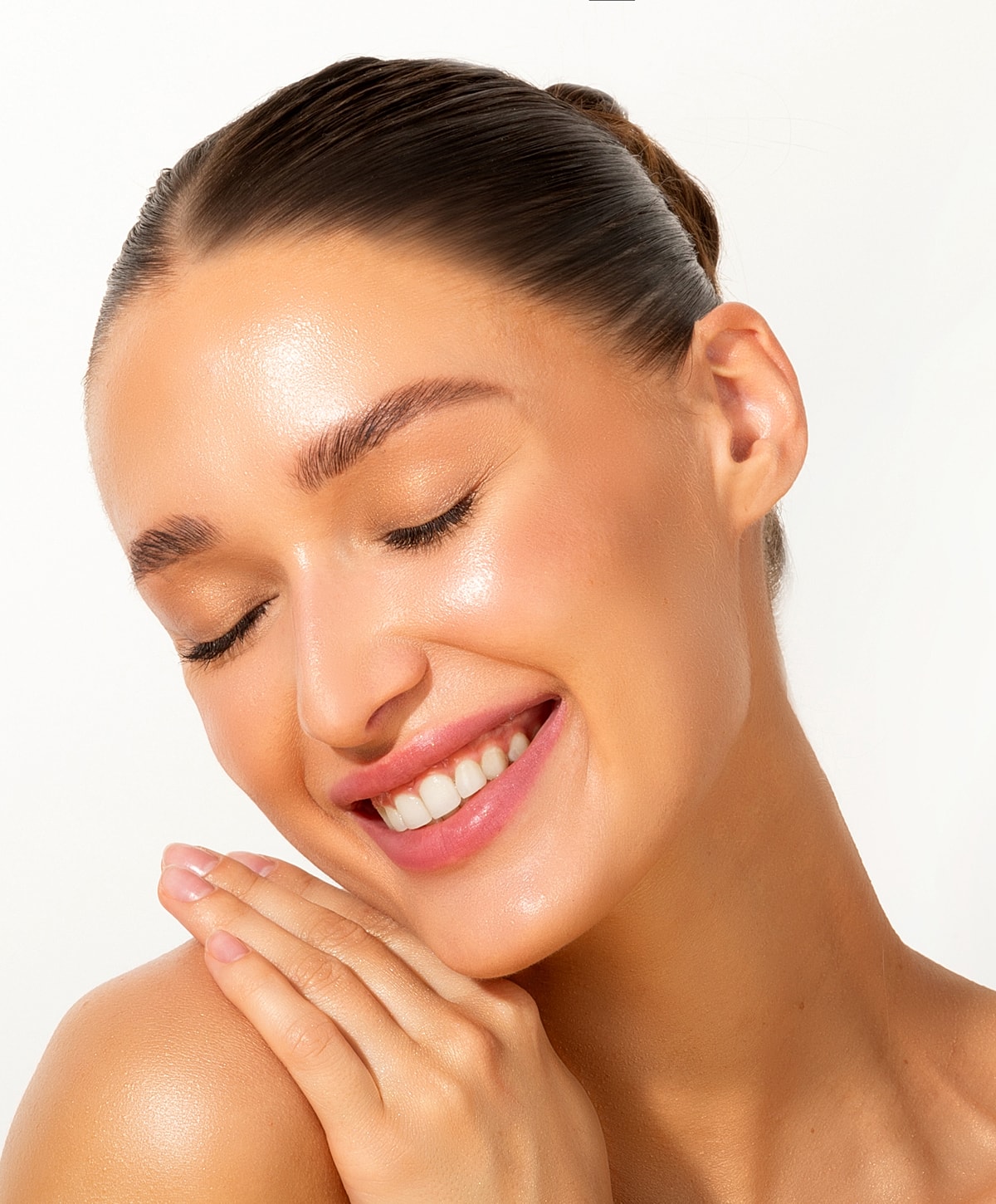 Smiling woman with natural, glowing skin.