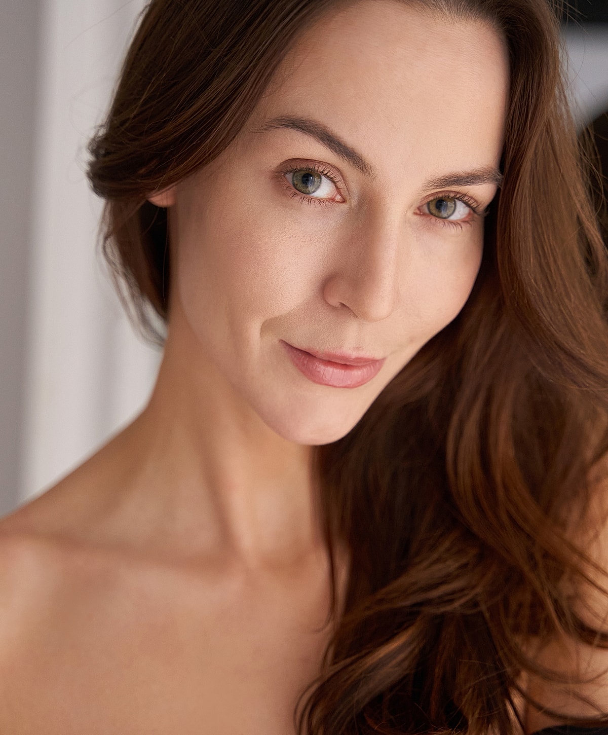 Close-up portrait of a woman with wavy hair.