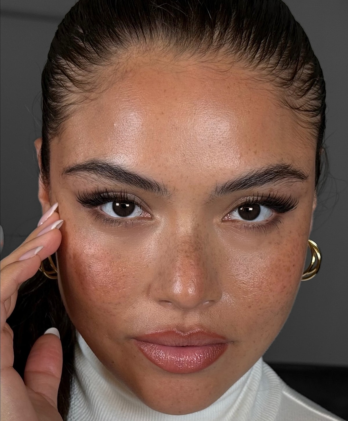 Close-up of person with healthy skin and makeup.