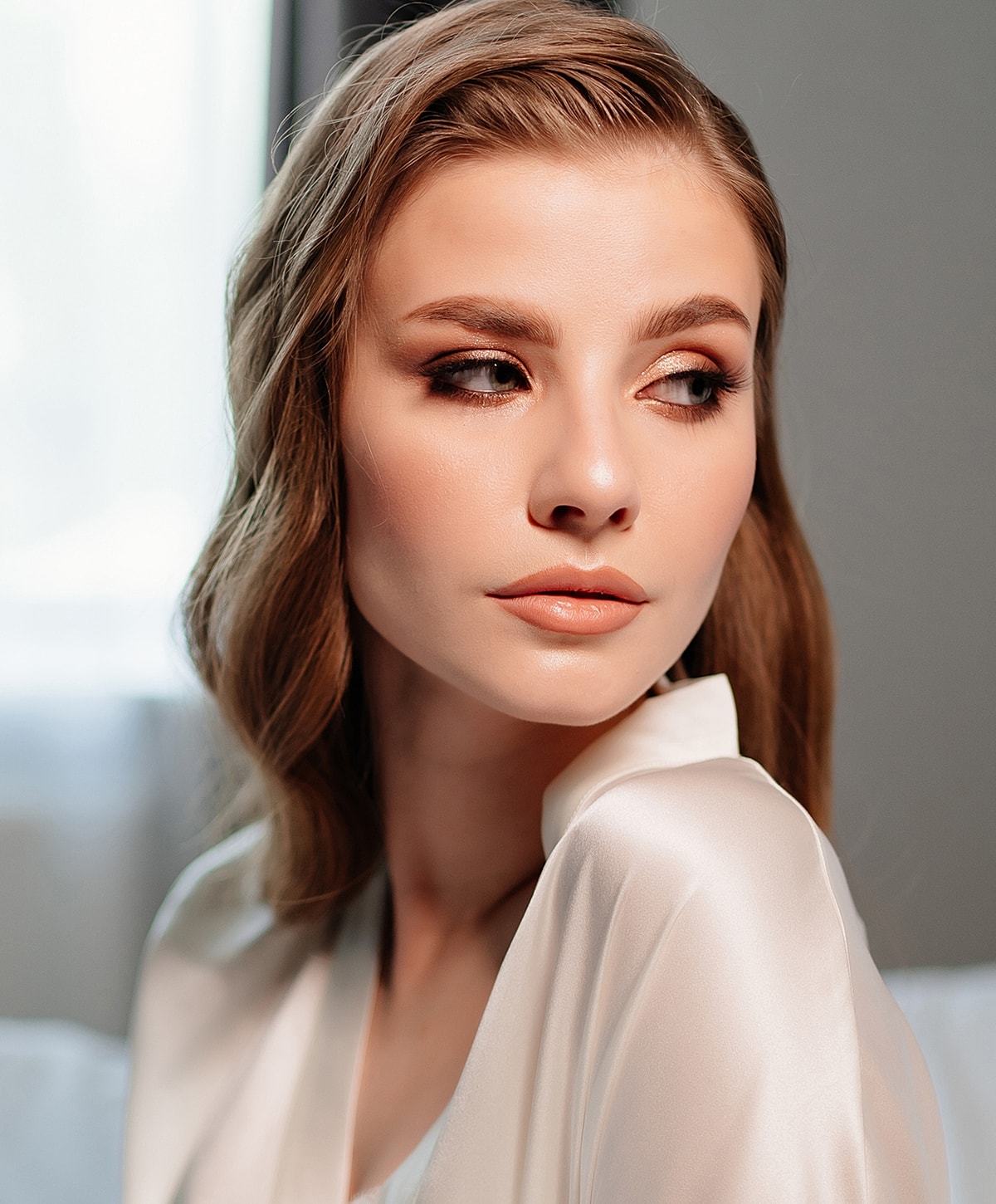 Woman with elegant hairstyle and subtle makeup.