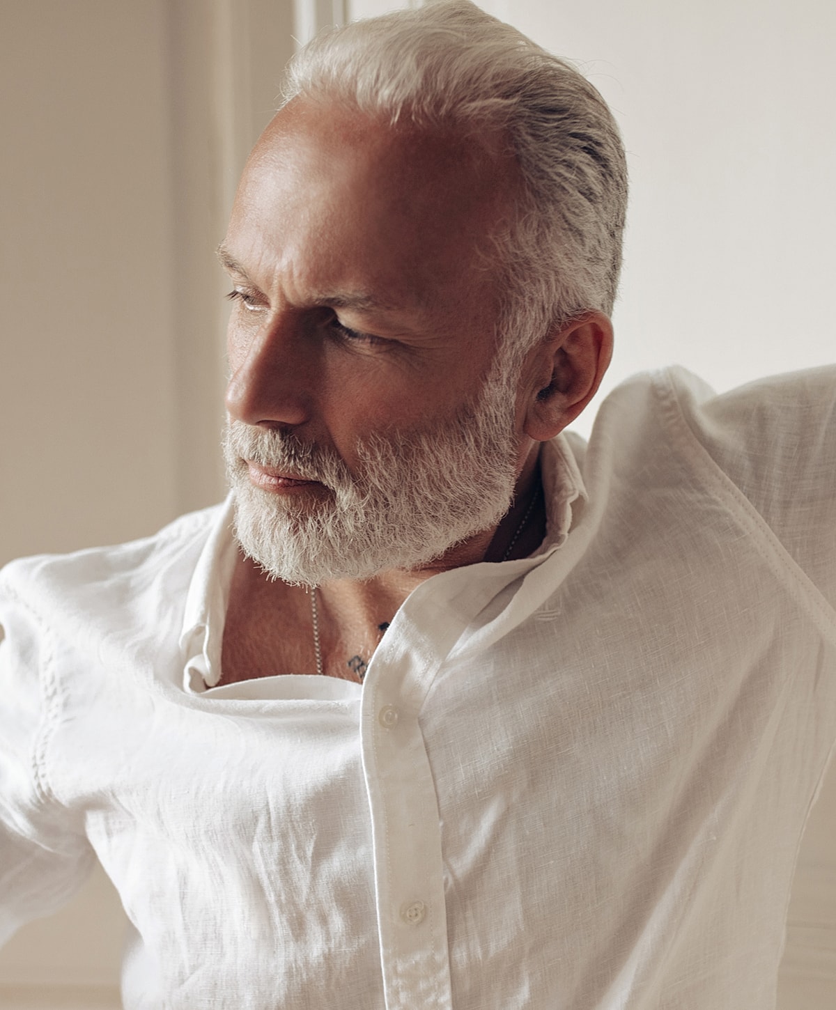 Mature man with white hair and beard.