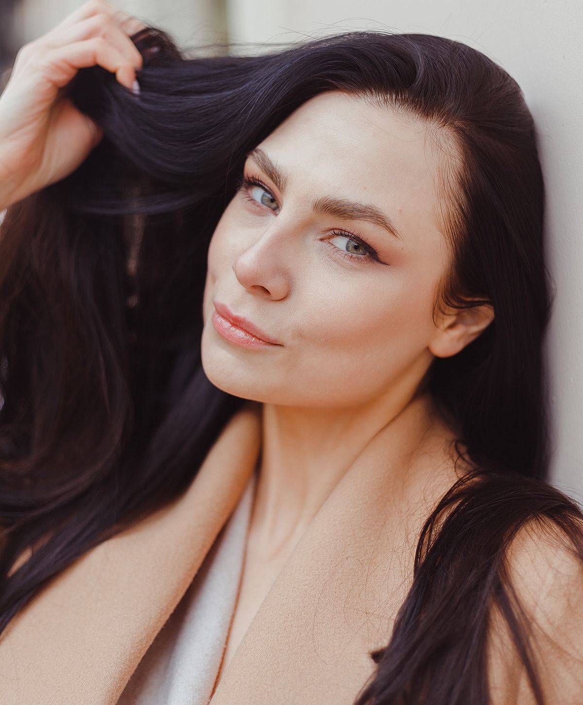 Woman with long black hair and soft smile.