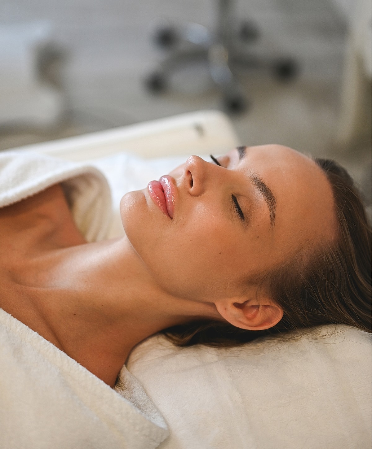 Woman relaxing during a facial treatment.