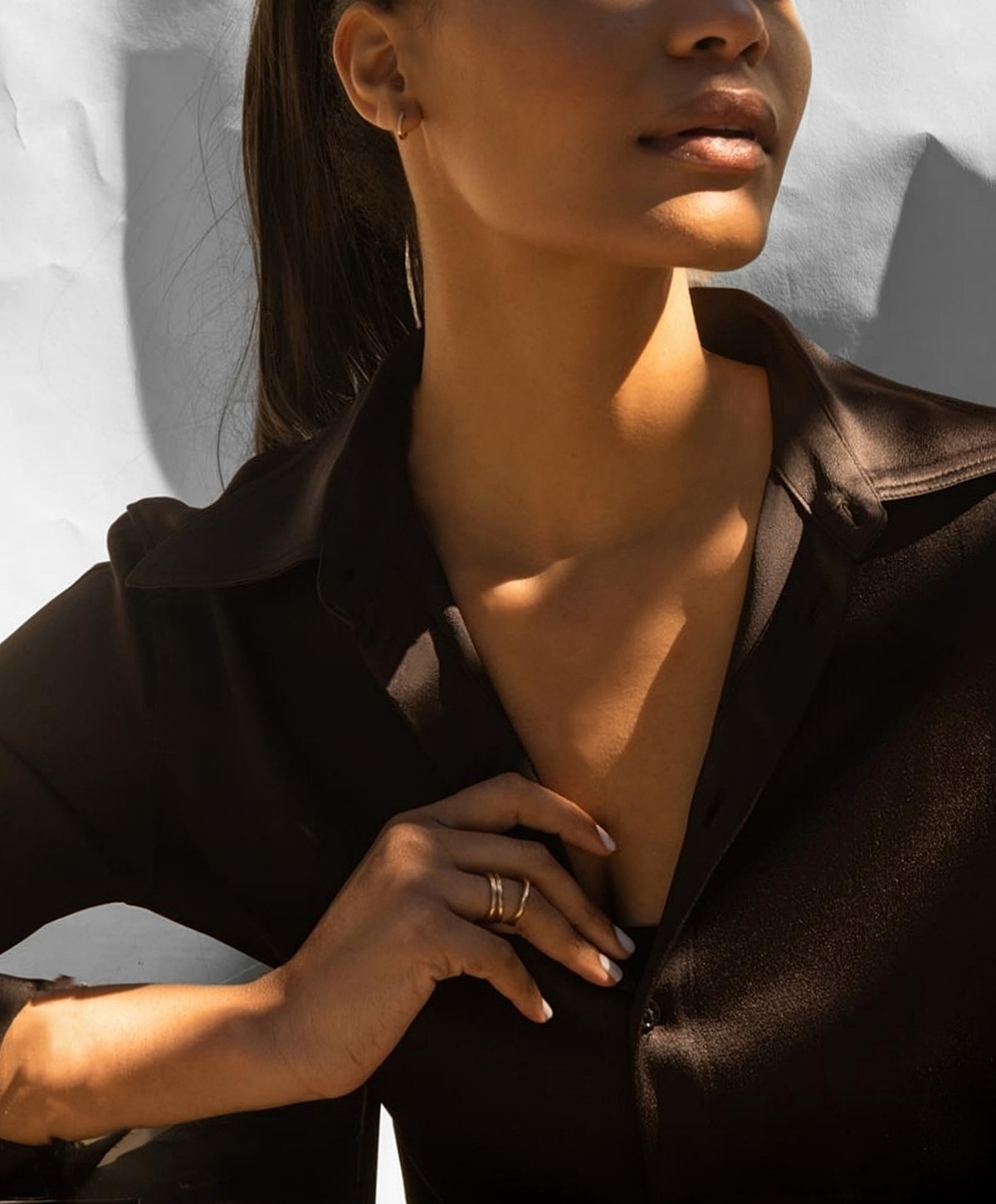 Woman in black shirt with soft lighting.