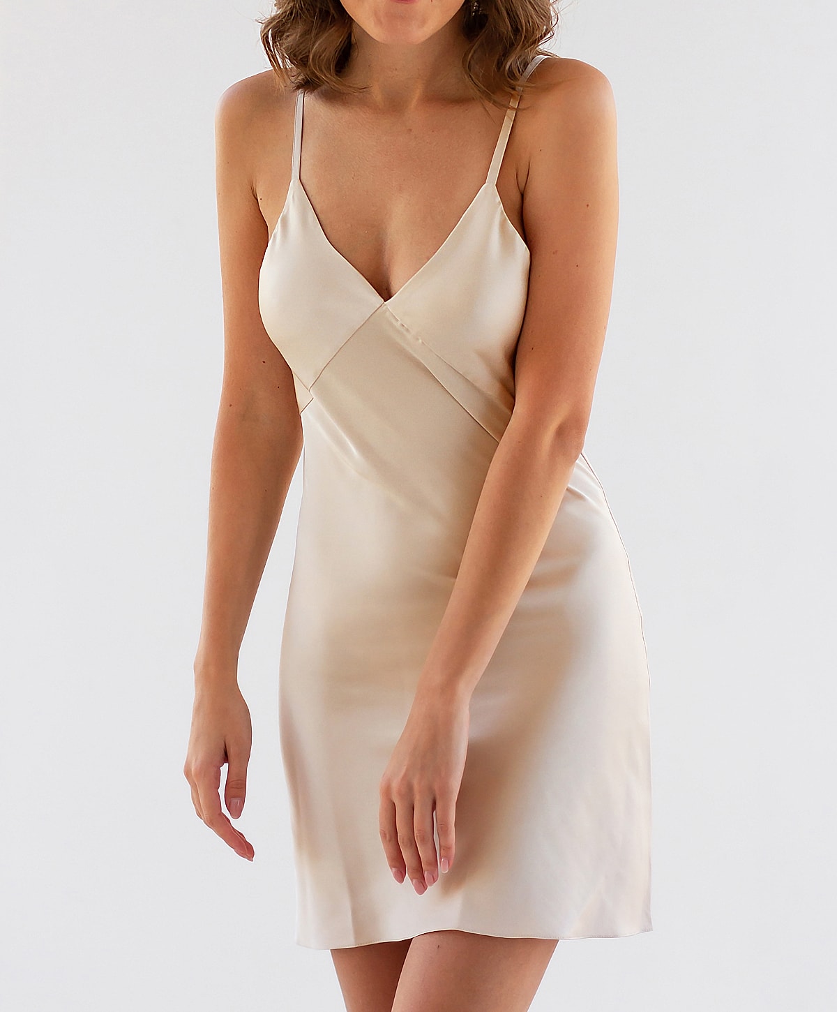 Model in a satin slip dress, natural pose.