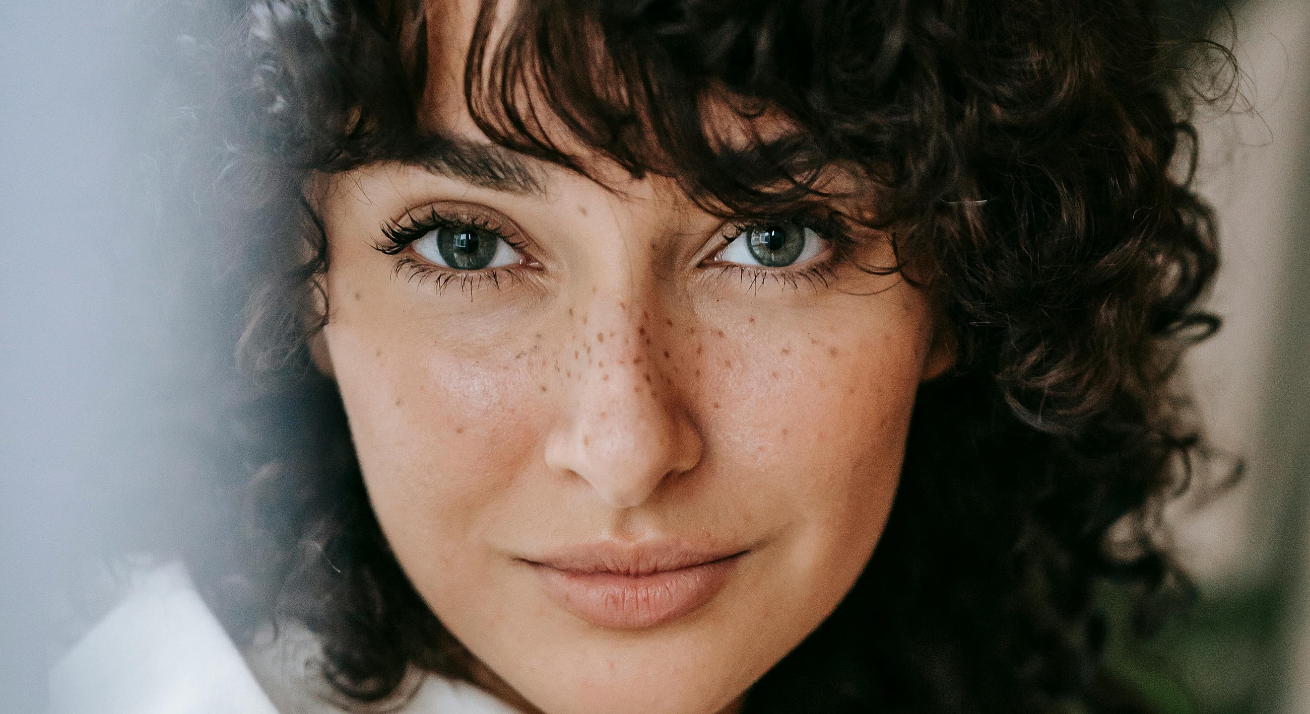 Close-up of a woman with curly hair.