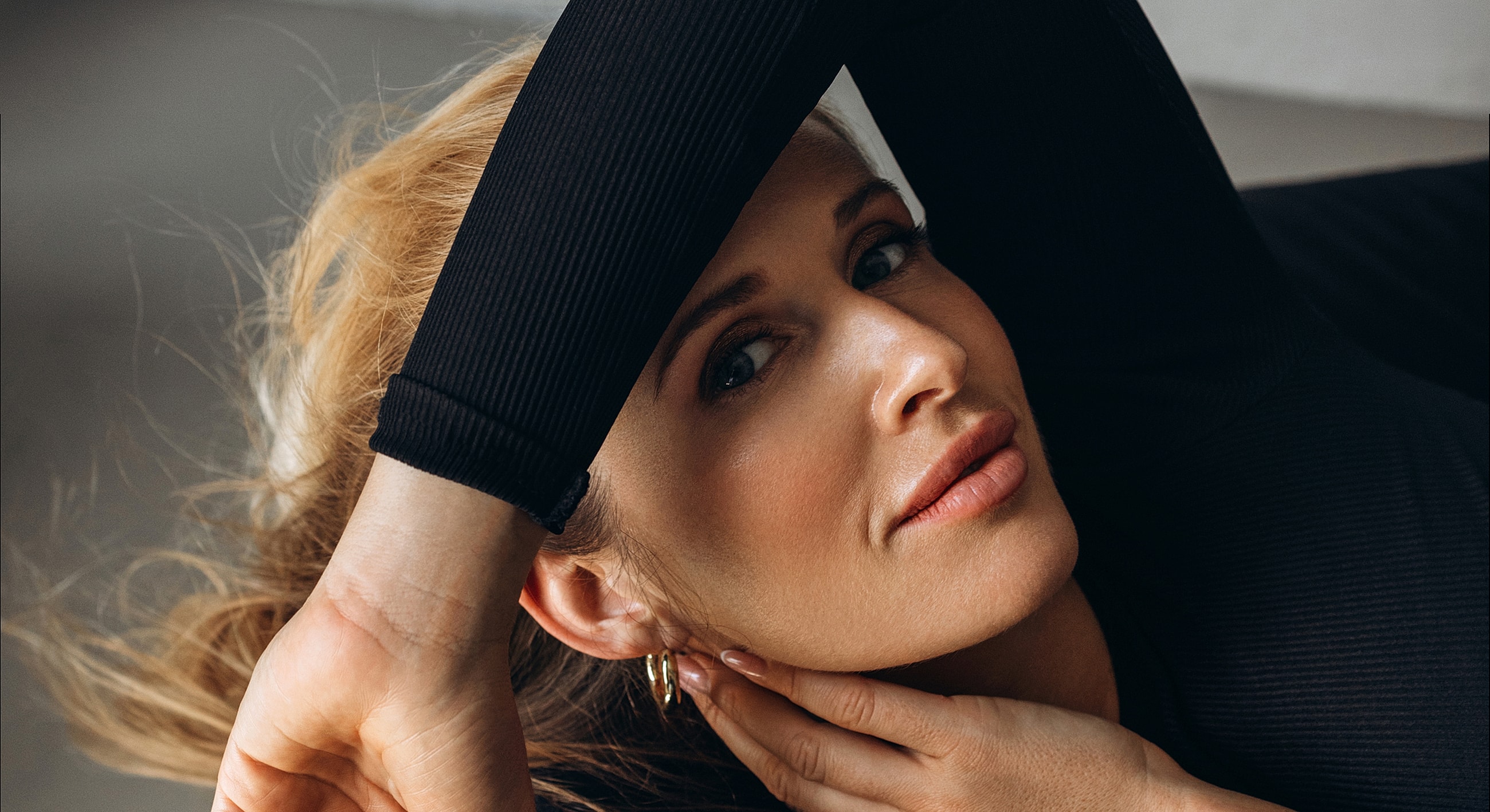 Person with light hair resting on arm.