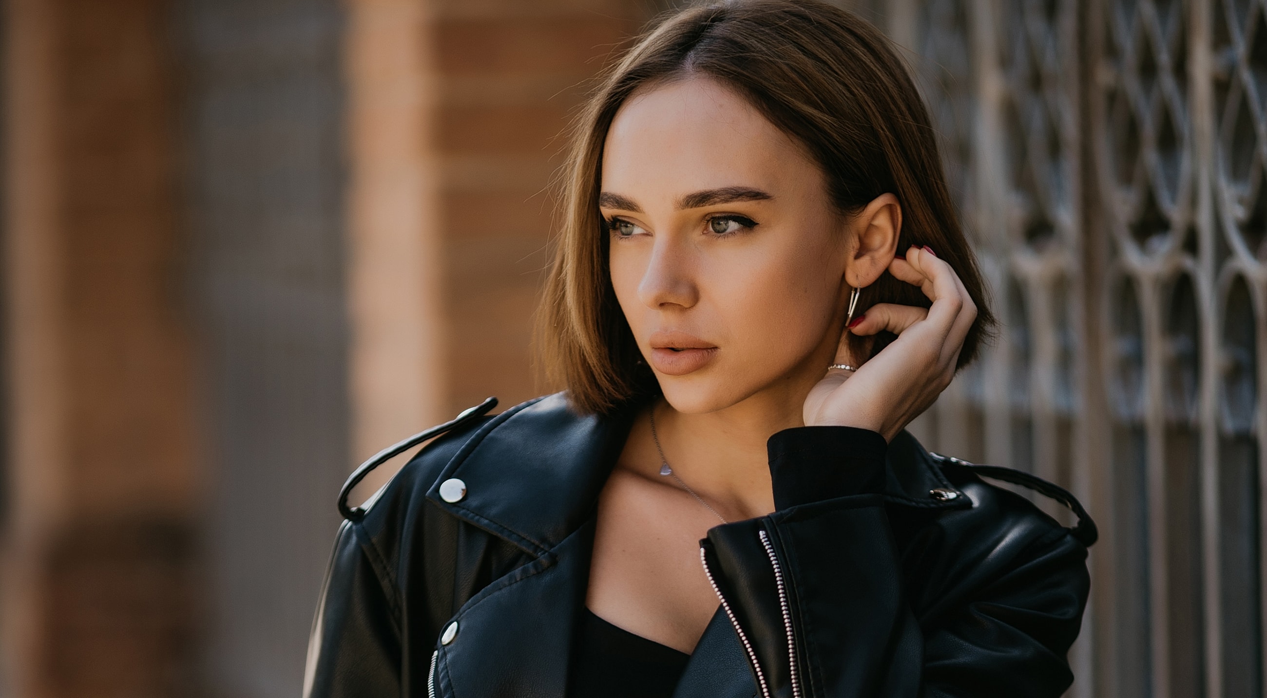 Woman with radiant skin and elegant hairstyle.